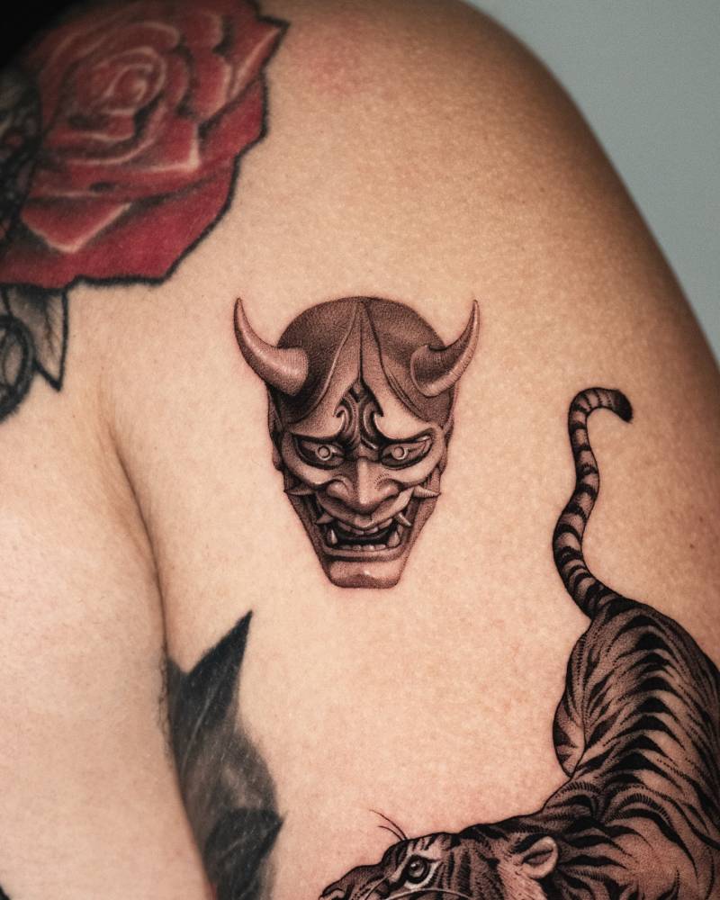 Hannya mask tattoo in micro-realistic style done on the shoulder.