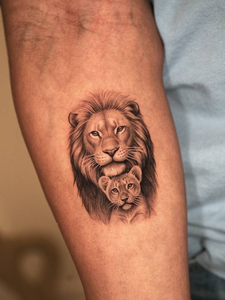Lion and cub portrait tattoo in micro-realistic style.