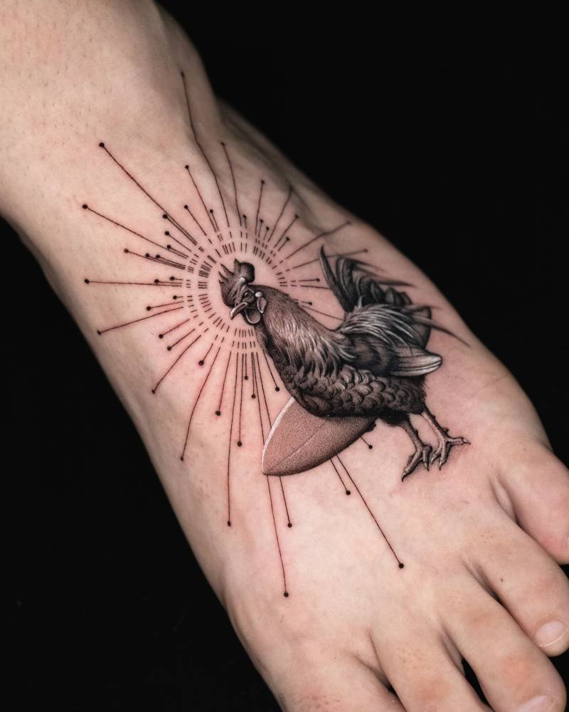 Surfer rooster tattoo located on the foot, micro-realistic style.