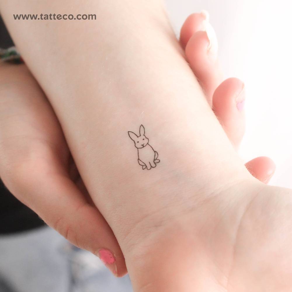 Sitting rabbit temporary tattoo located on the wrist.