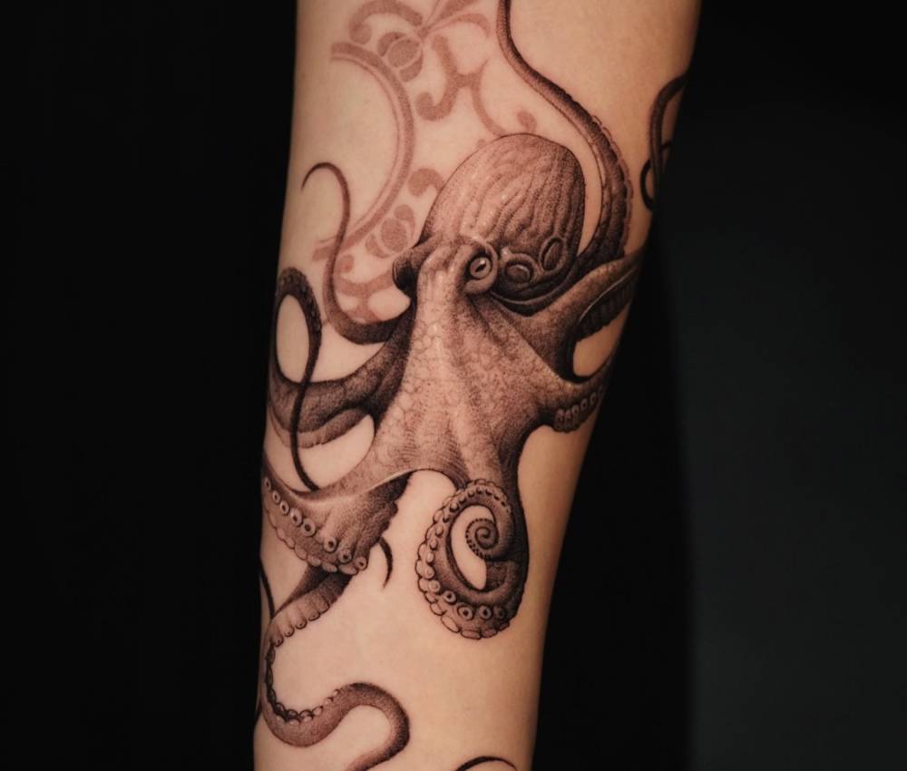 Micro-realistic style octopus tattoo placed on the forearm.