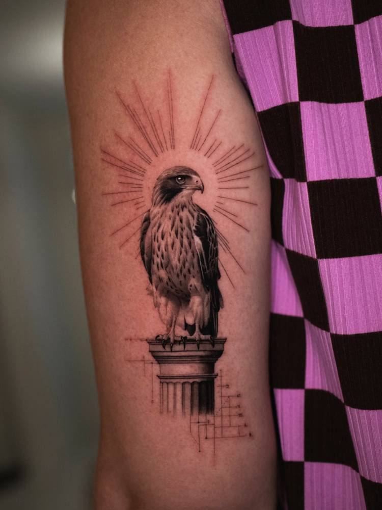 Hawk tattoo located on the tricep, done in micro-realistic style.