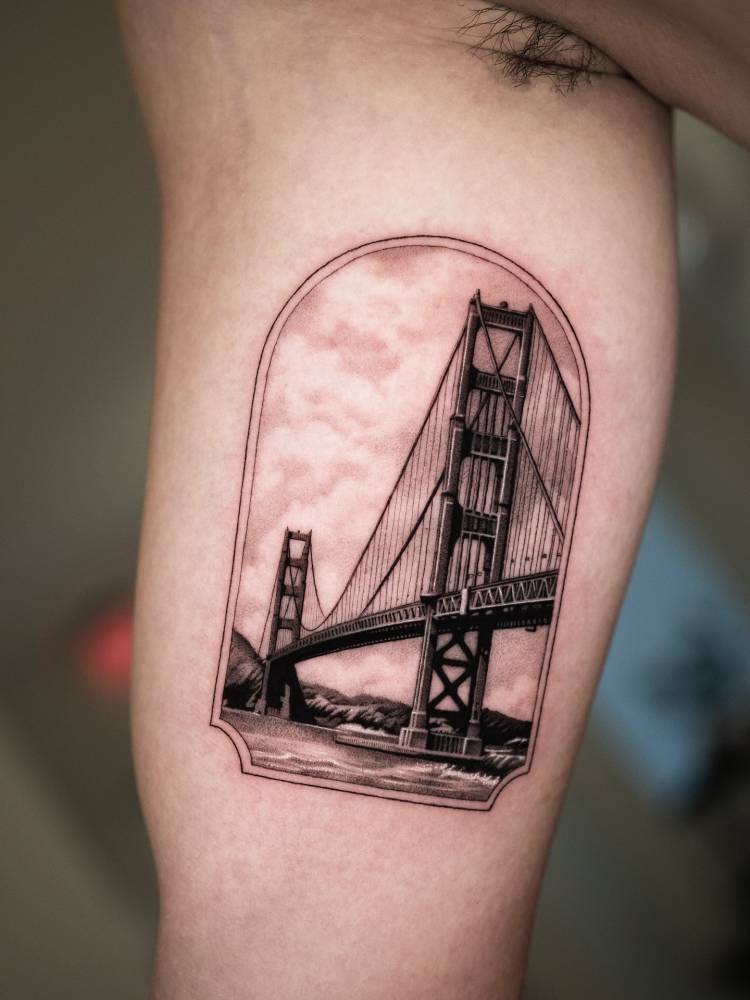 Golden Gate bridge tattoo located on the inner arm, micro-realistic style.