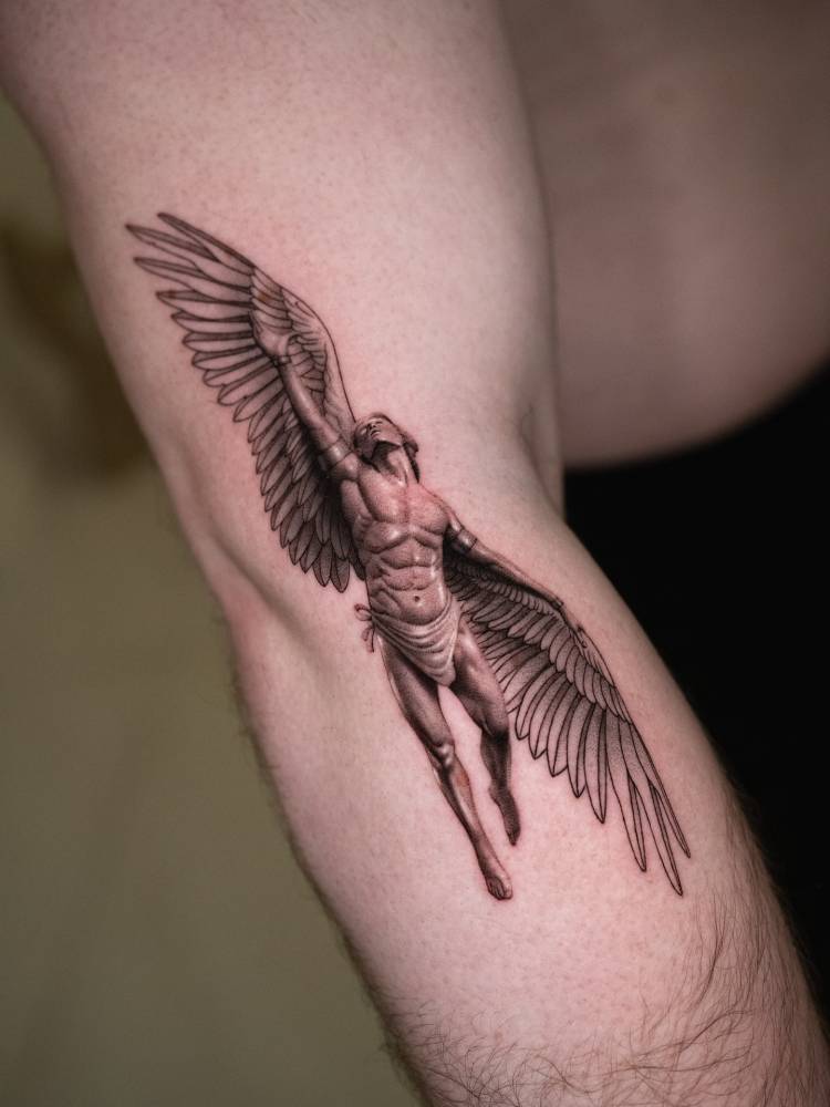 Icarus tattoo in micro-realistic style located on the arm.
