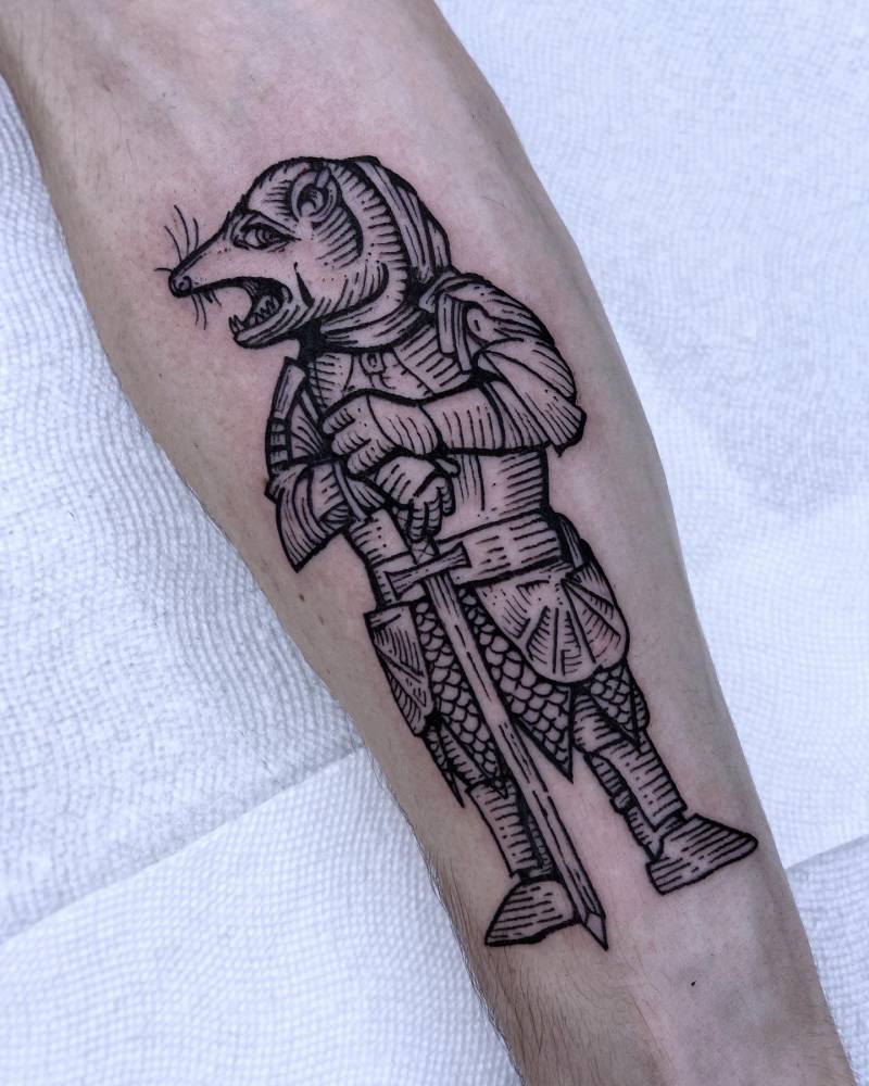 Knight rat tattoo in engraving style placed on the inner forearm.