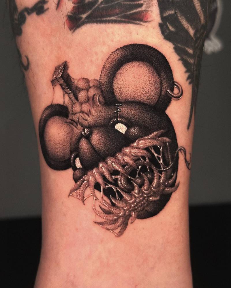 Scary teddy tattoo located on the shin, dotwork style.