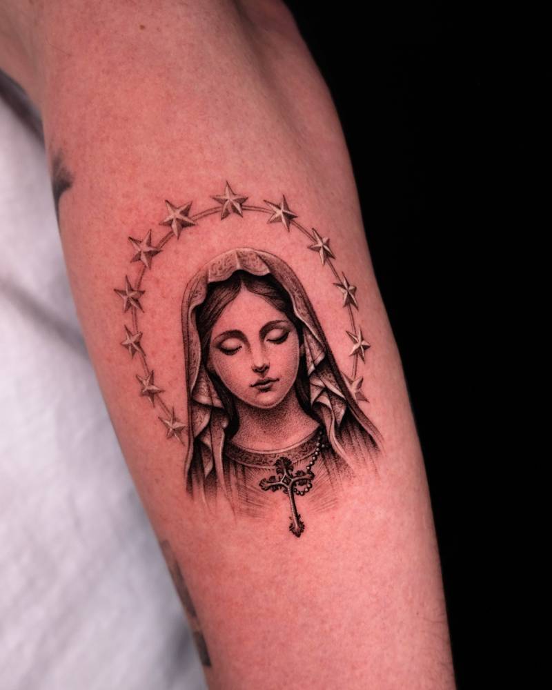 Micro-realistic style Virgin Mary portrait tattoo placed on the forearm.