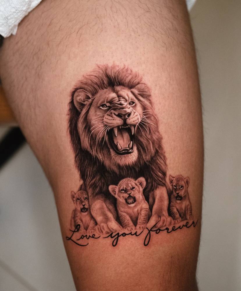 Micro-realistic style Lion and cubs tattoo located on the thigh.