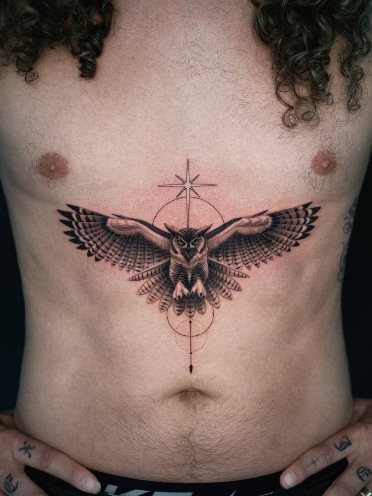 Black and grey owl tattoo located on Mark Ballas' stomach.