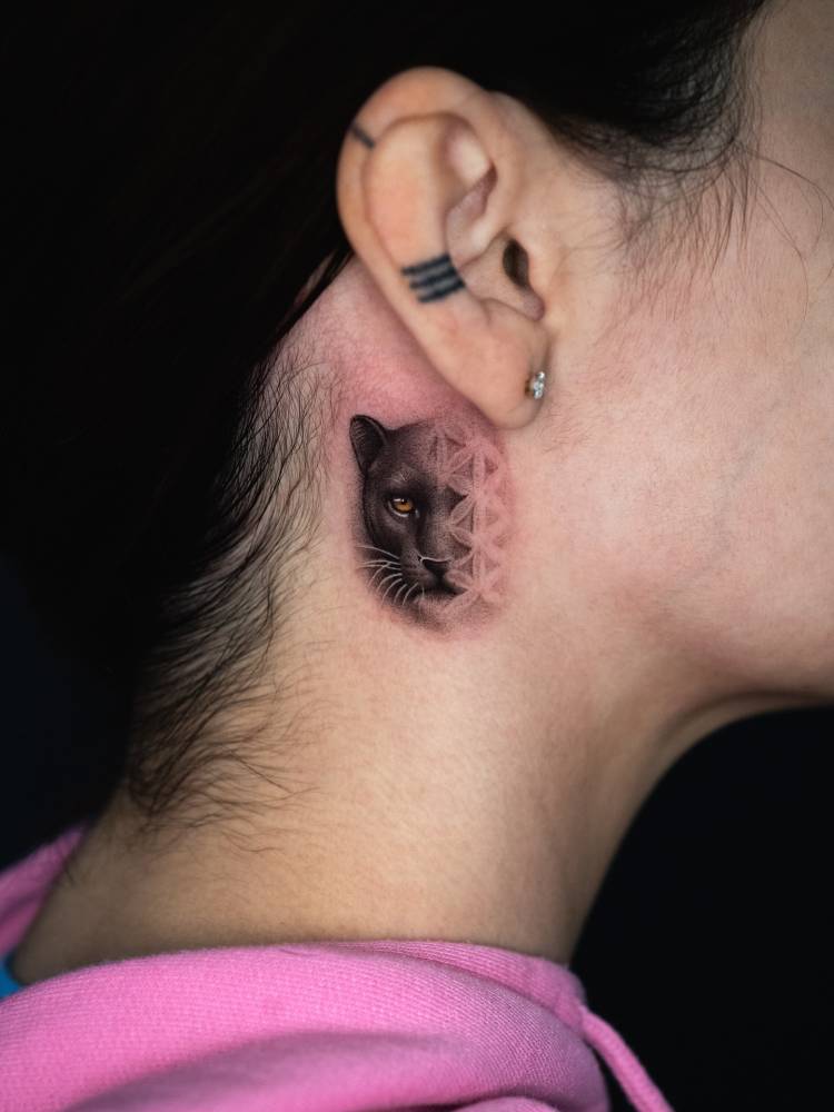 Black panther and flower of life pattern tattooed on the neck.