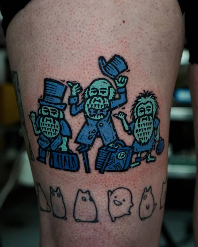 'Haunted Mansion' with gnomes tattooed on the thigh.