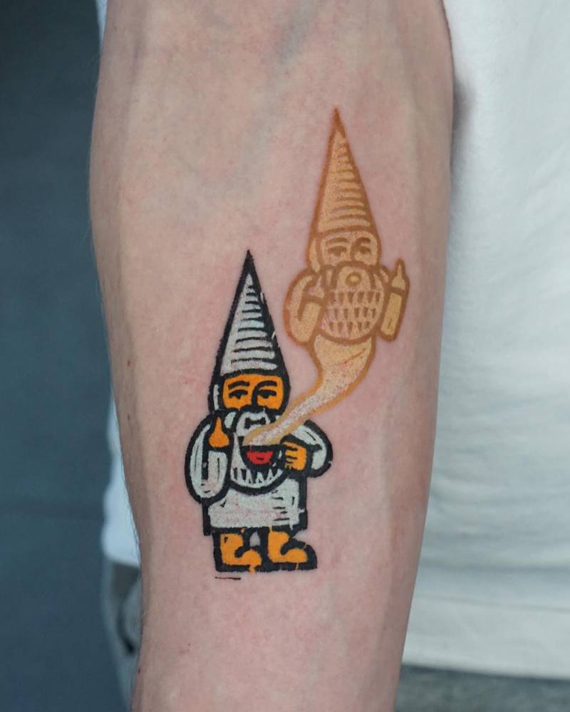 Pop art style gnome tattoo located on the inner forearm.