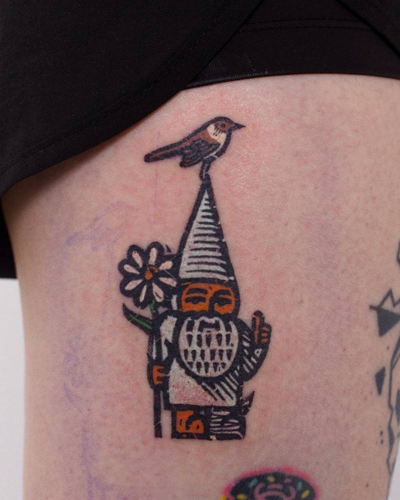 Gnome tattoo located on the thigh, pop art style.