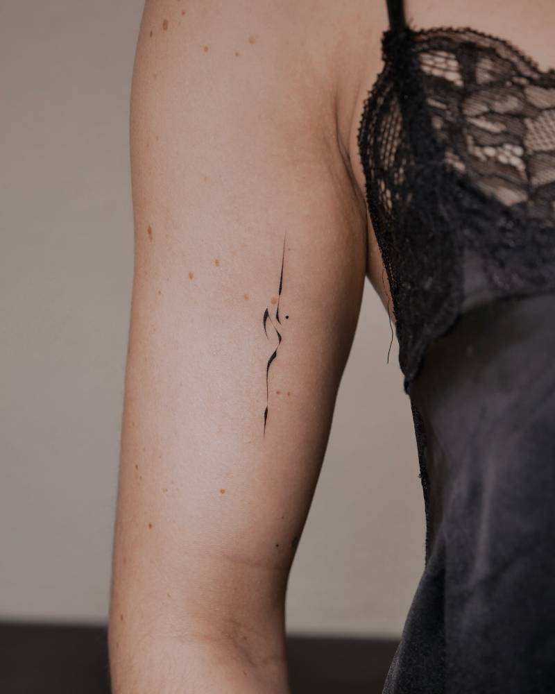 Abstract ornament tattooed on the bicep.