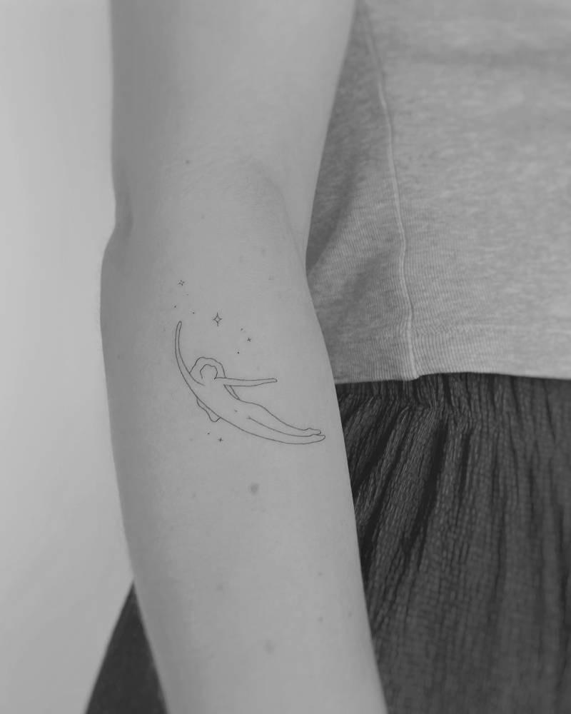 Crescent Lady tattoo in fine line style located on the forearm.