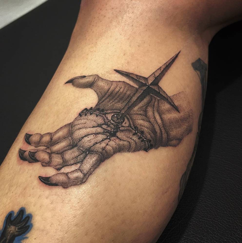 Dotwork style stabbed hand tattoo located on the calf.