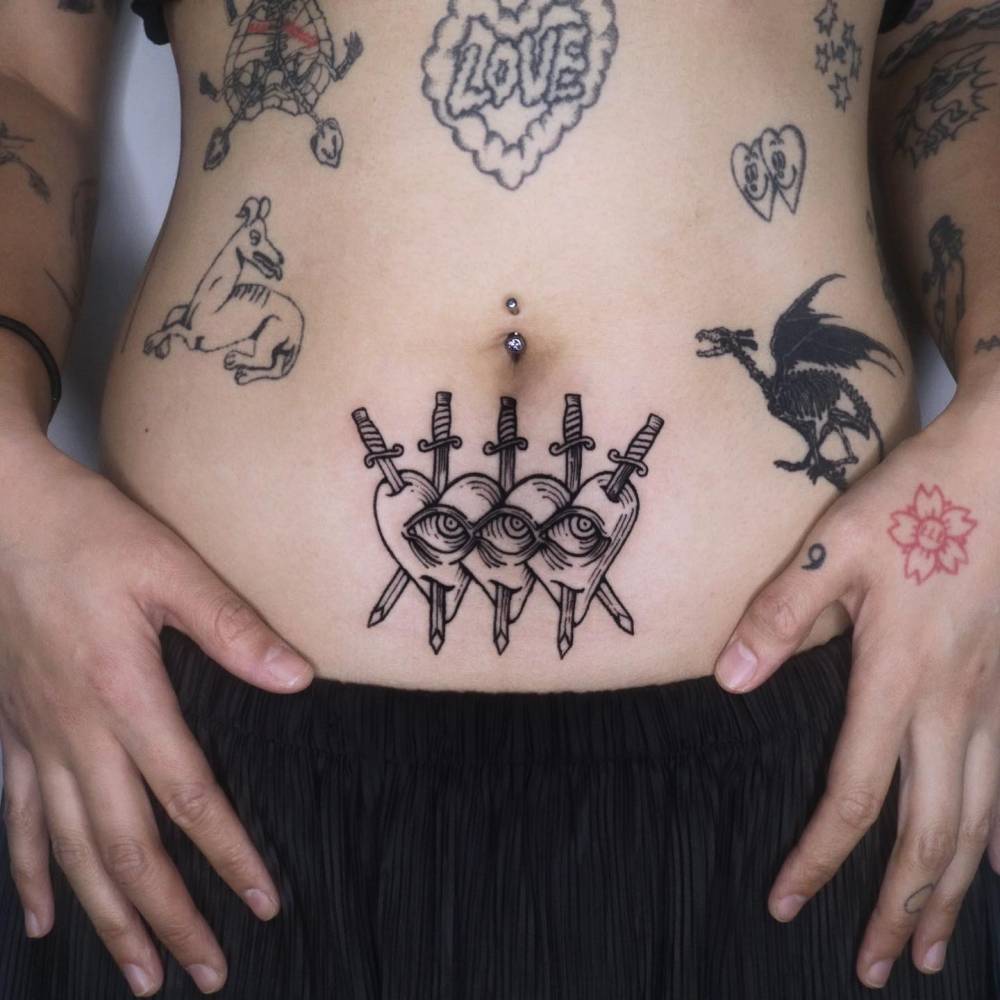 Hearts and swords tattoo located on the stomach, blackwork style.