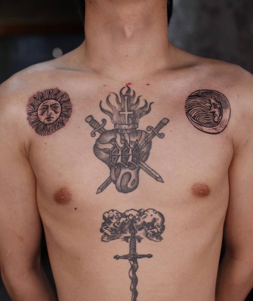 Individual matching sun and moon tattoos located on the shoulders.