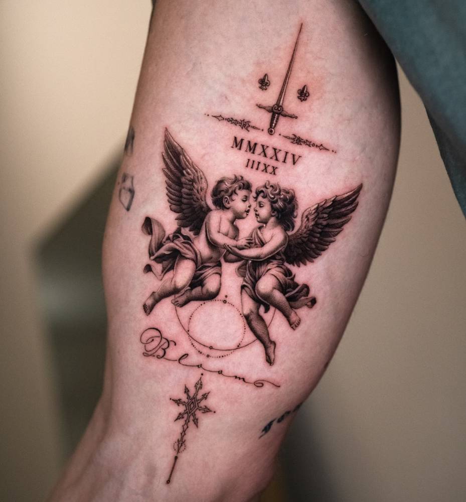 Micro-realistic style cherubs tattoo located on the inner arm.