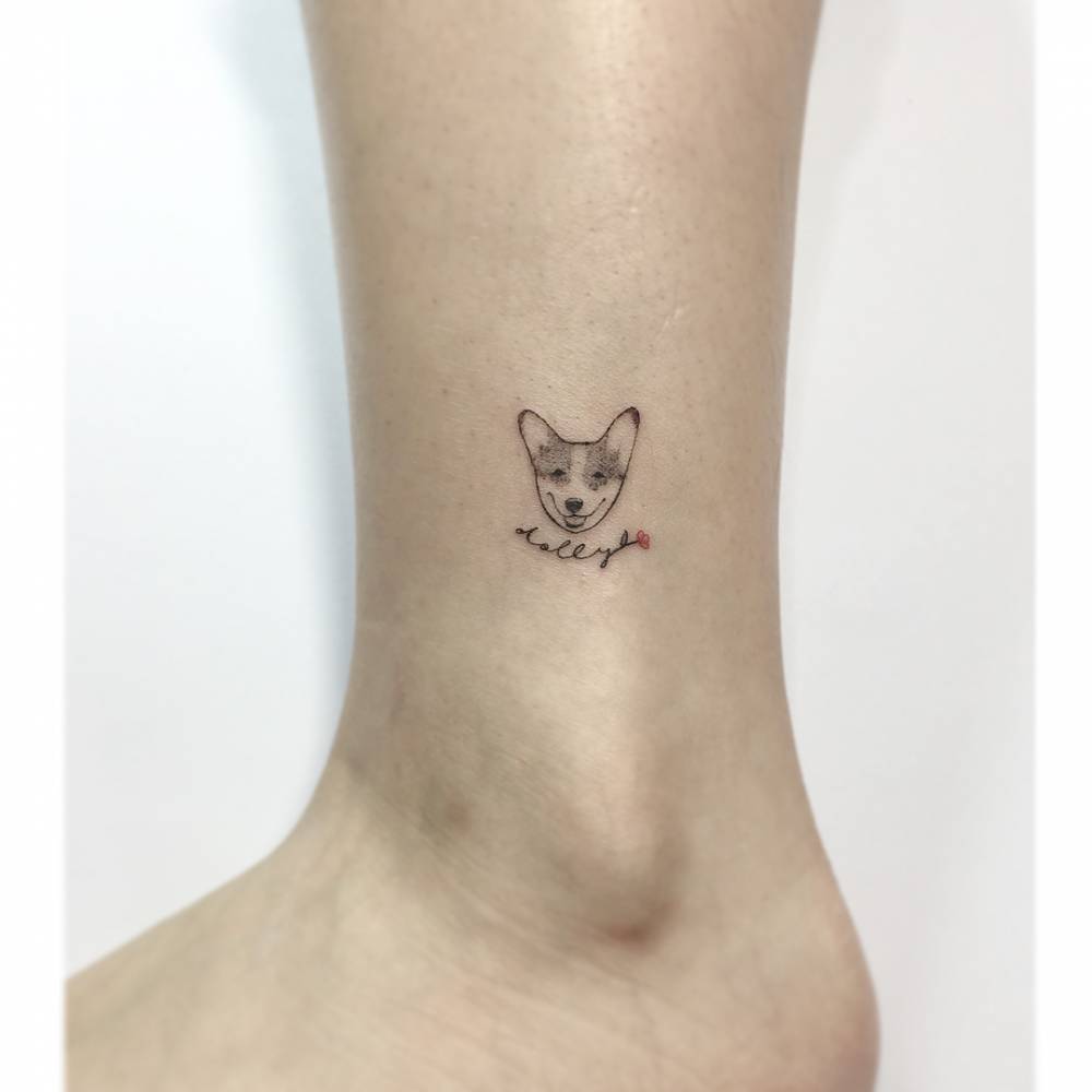 Illustrative style dog portrait tattoo located on the ankle.