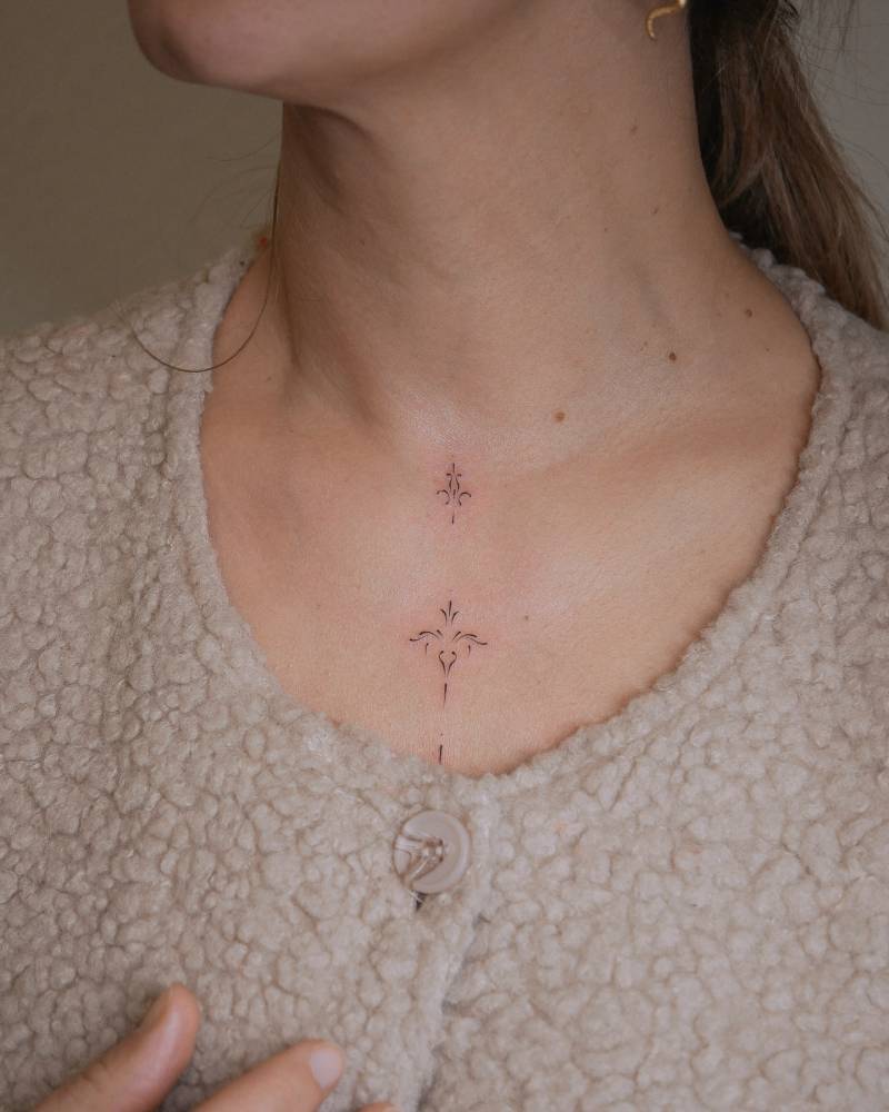 Fine line style ornamental design tattooed on the chest.