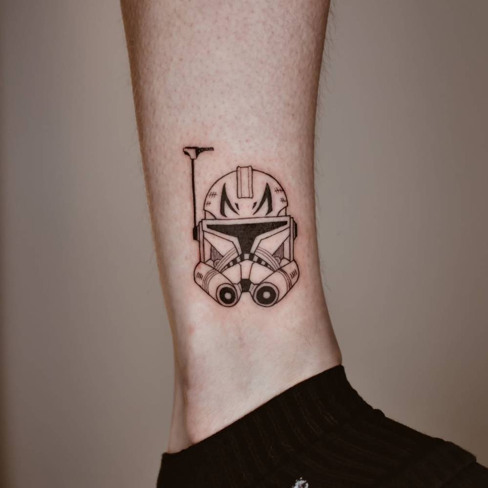 Captain Rex helmet tattoo located on the ankle.