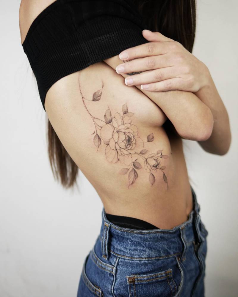 Illustrative style peony tattoo located on the side boob.