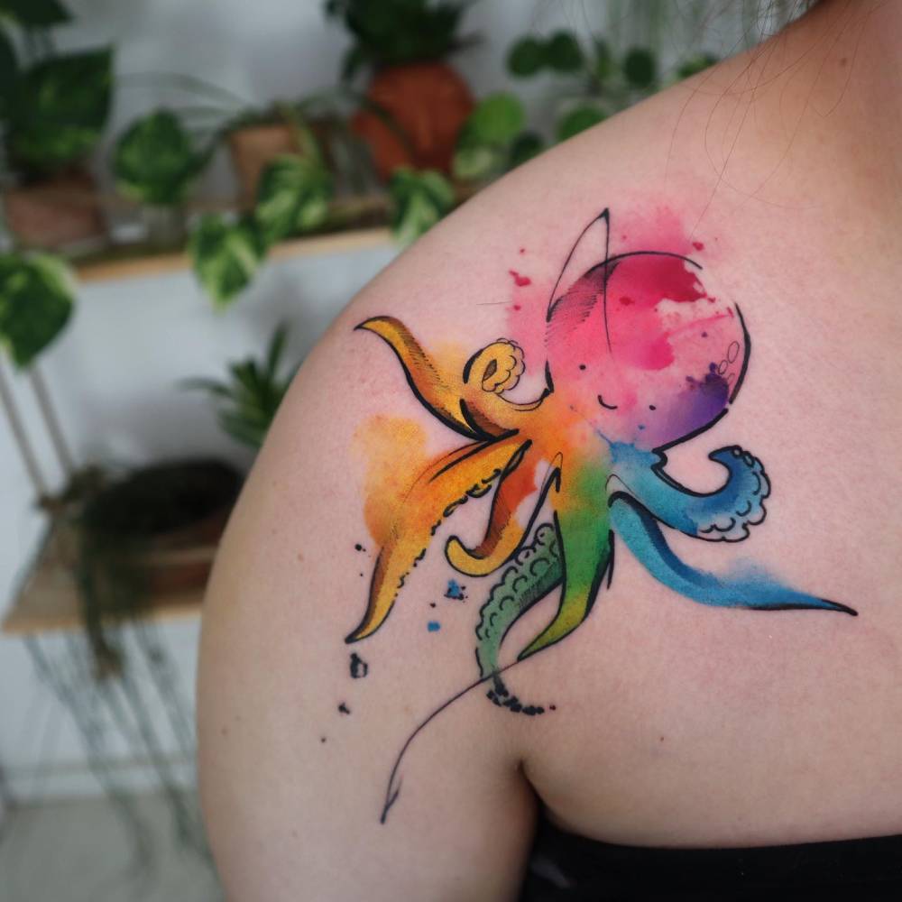 Watercolor style octopus tattoo located on the shoulder.