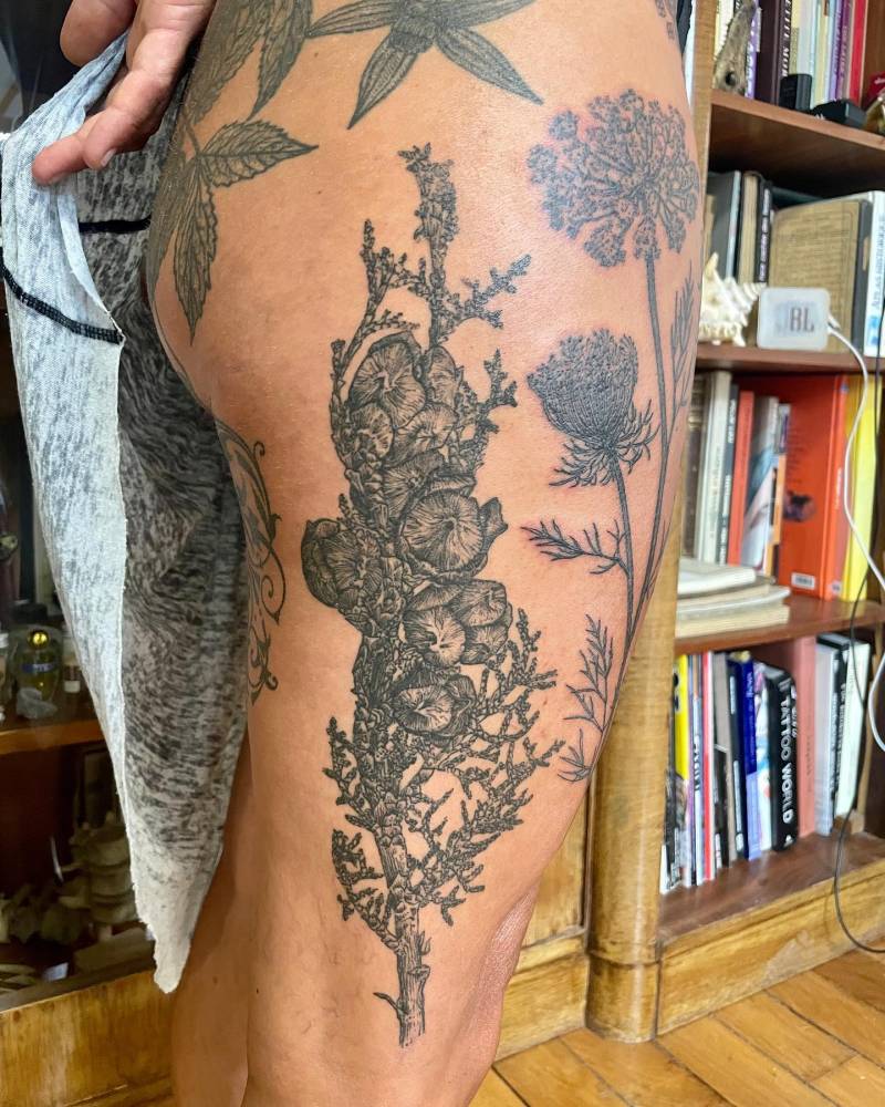 Healed cypress sprouts tattoo located on the thigh.