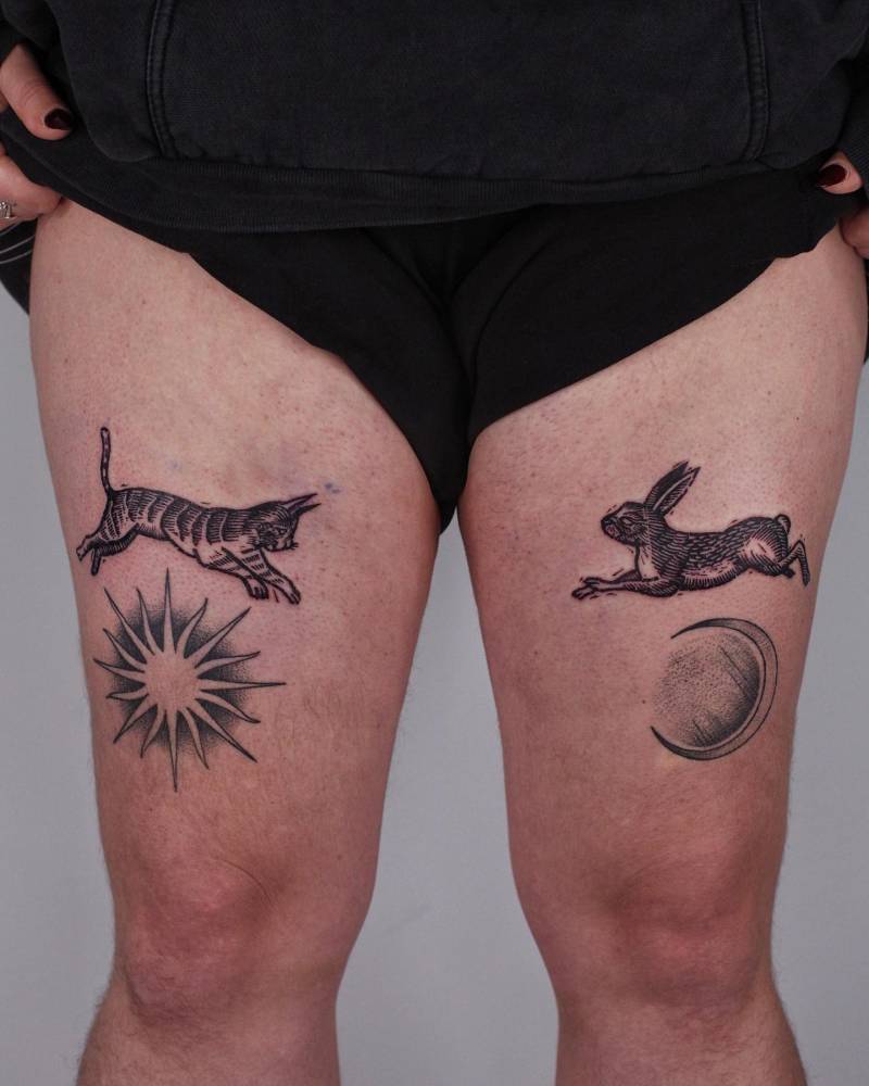 Cat and hare individual matching tattoo located on the thighs.