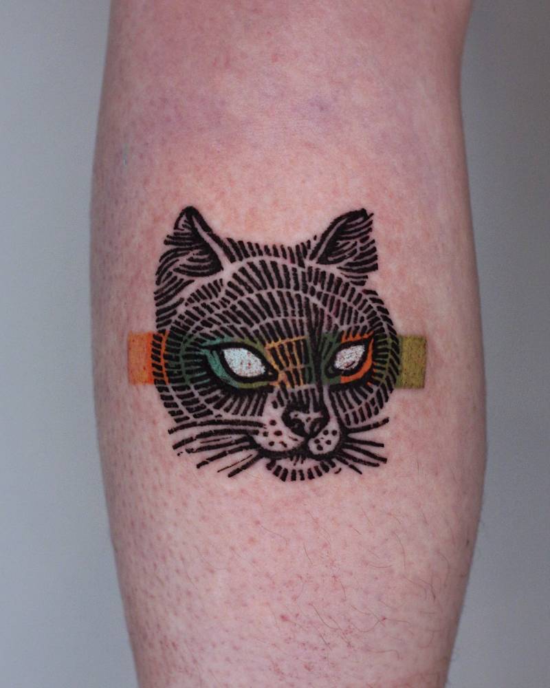 Engraving style cat portrait tattoo located on the shin.