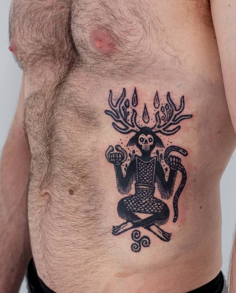 Cernunnos tattoo in blackwork style placed on the rib.