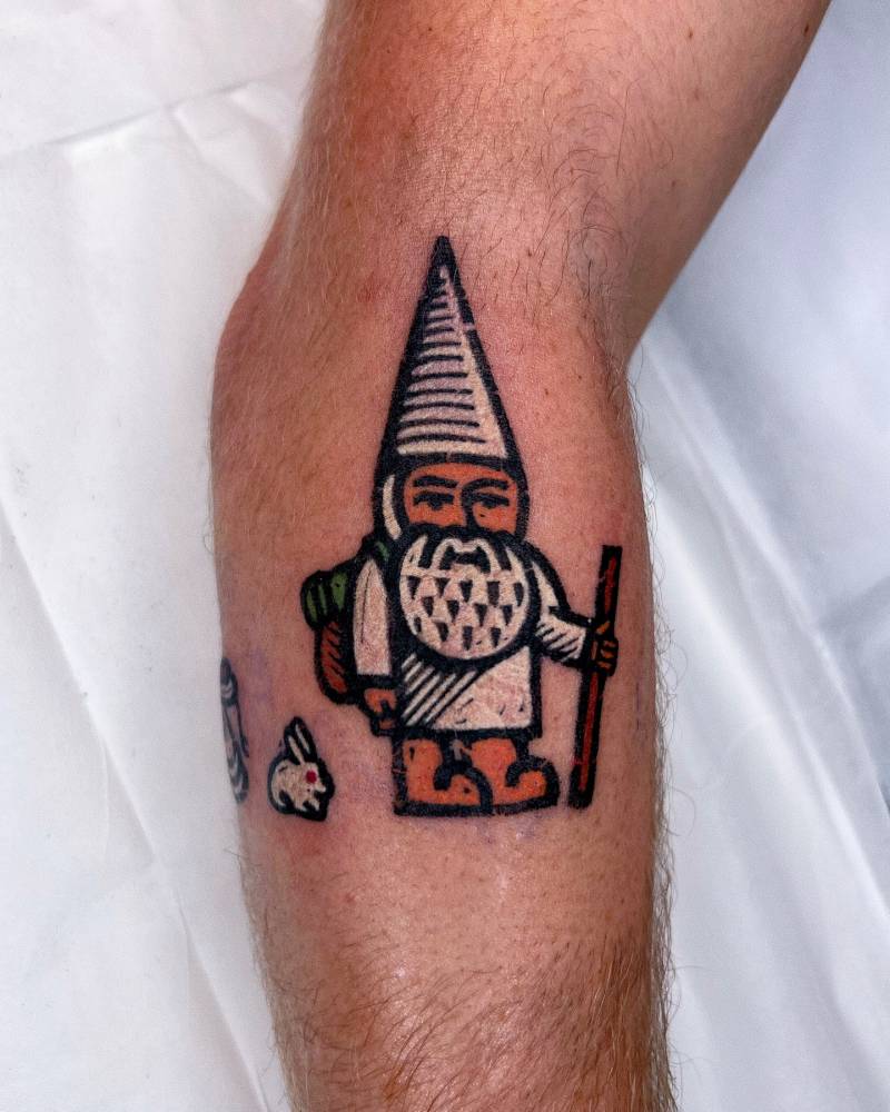Gnome explorer tattooed on the forearm, pop art style.