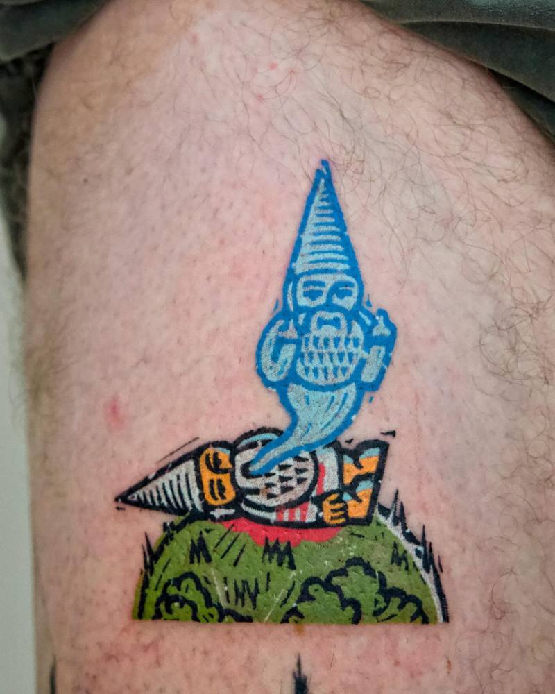 Ghost gnome tattoo located on the thigh, done in pop art style.
