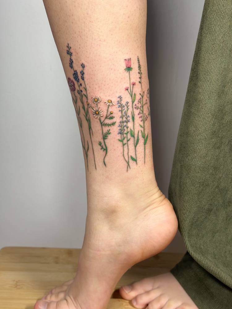 Flower collection tattooed on the ankle.
