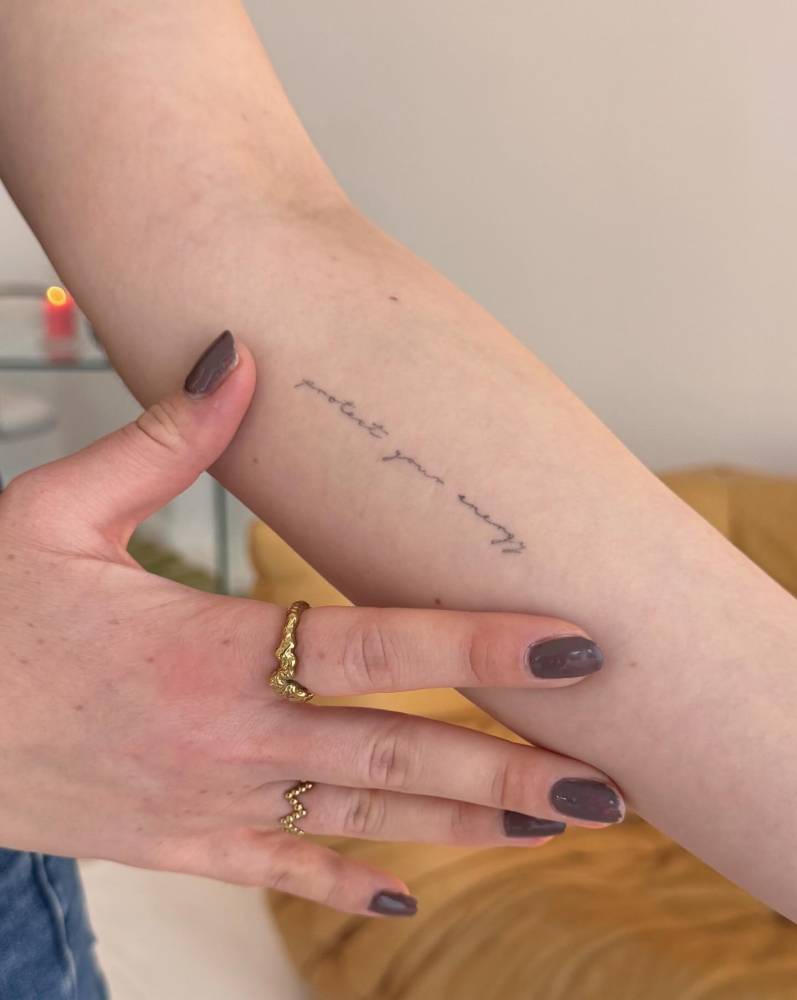 Handwritten font "protect your energy" lettering tattoo (healed).