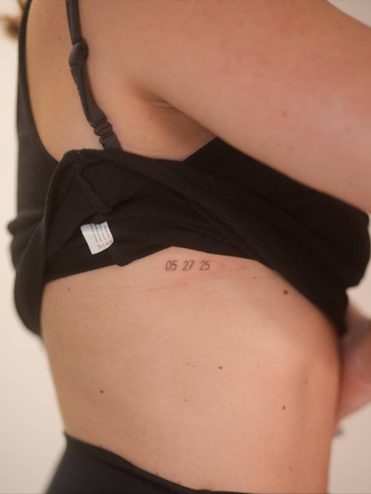 Date tattoo located on the rib.