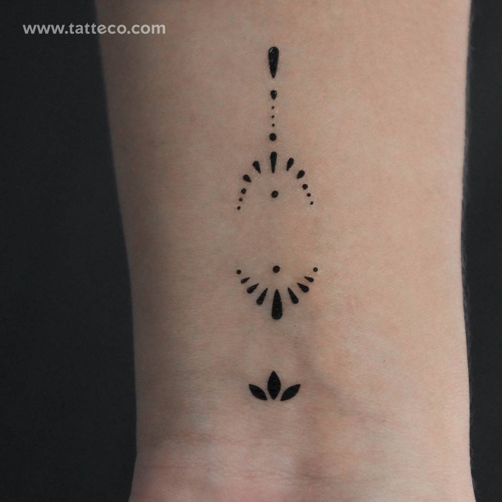 Ornamental composition temporary tattoo located on the wrist.