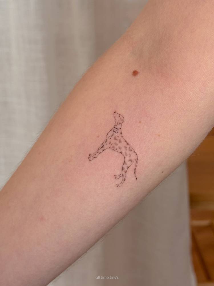 Dalmatian tattoo in illustrative style located on the inner forearm.