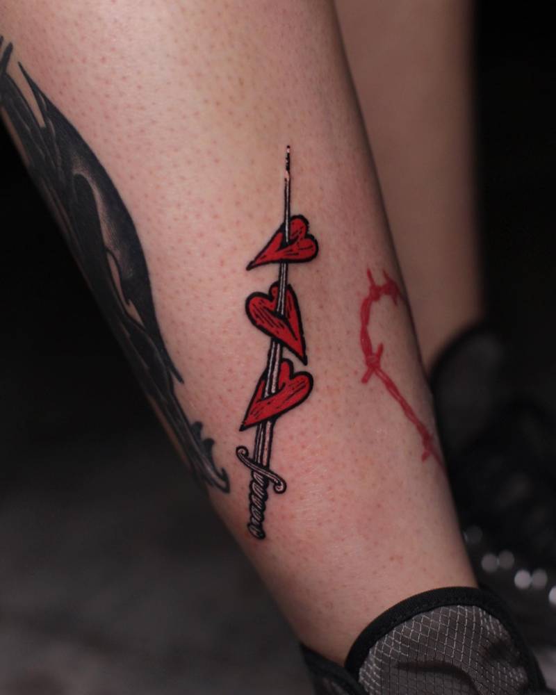 Hearts and sword tattoo located on the shin.