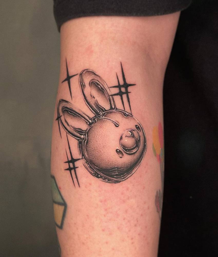 Metallic effect bunny tattoo located on the forearm.