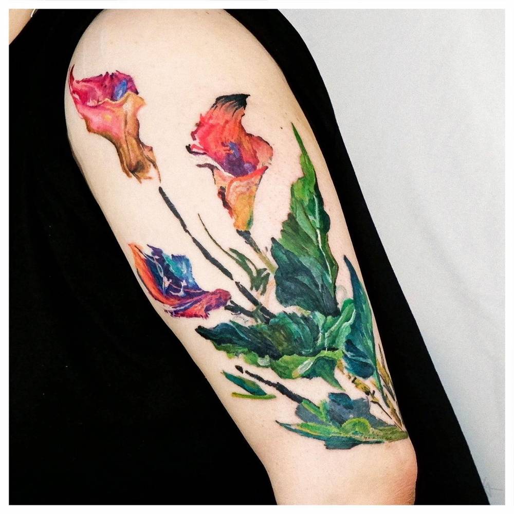 Calla Lily tattoo located on the upper arm, watercolor style.