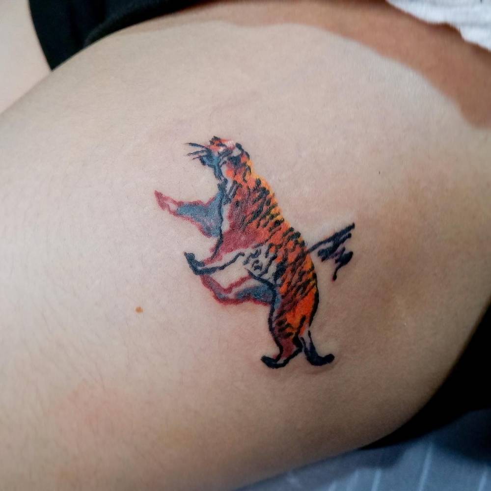 Crayon effect tiger tattoo located on the thigh.