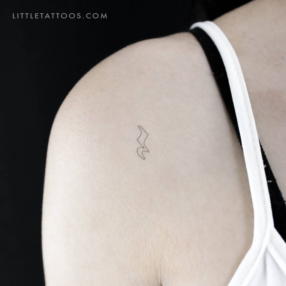 Minimalistic style crotchet rest temporary tattoo located on the shoulder.
