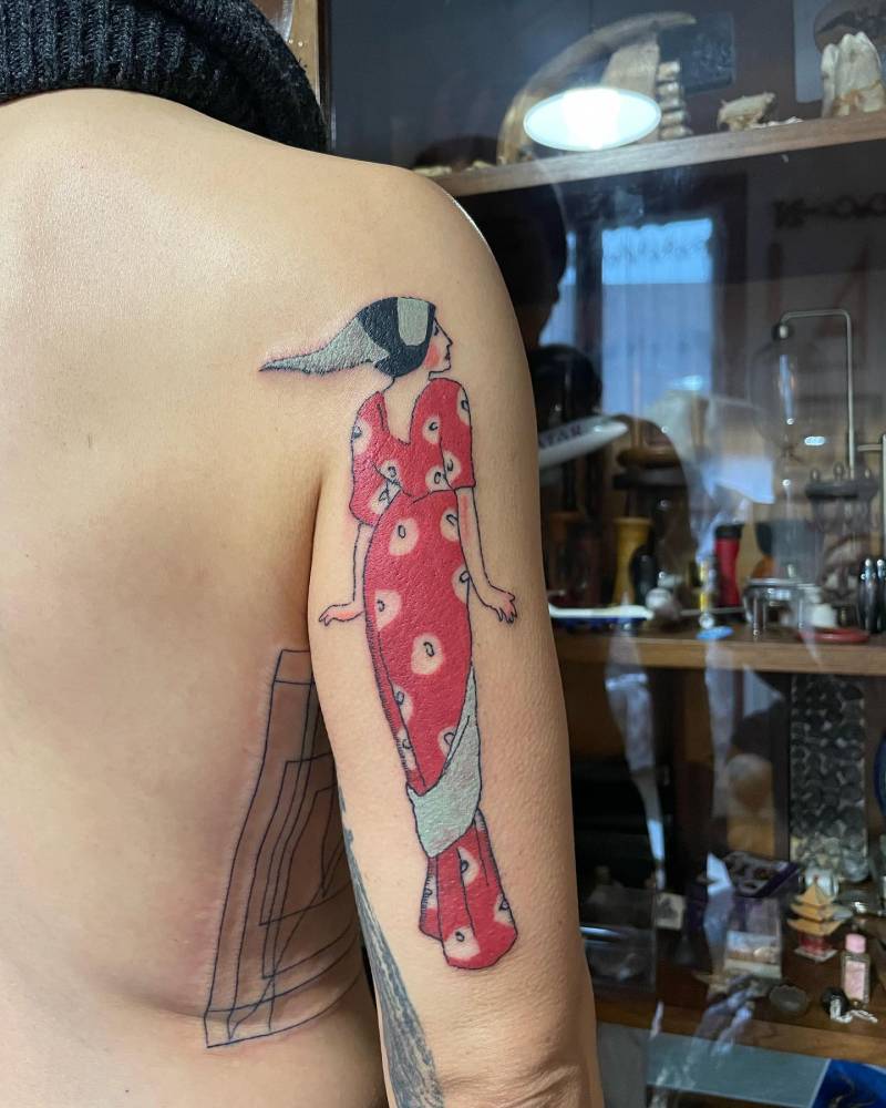 Contemporary style lady tattoo located on the tricep.