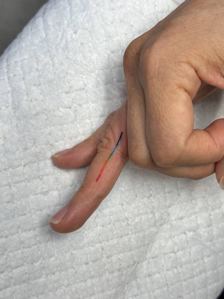 Visible spectrum tattoo placed on the finger.