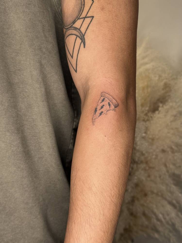 Lightning bolt pizza tattoo located on the forearm.