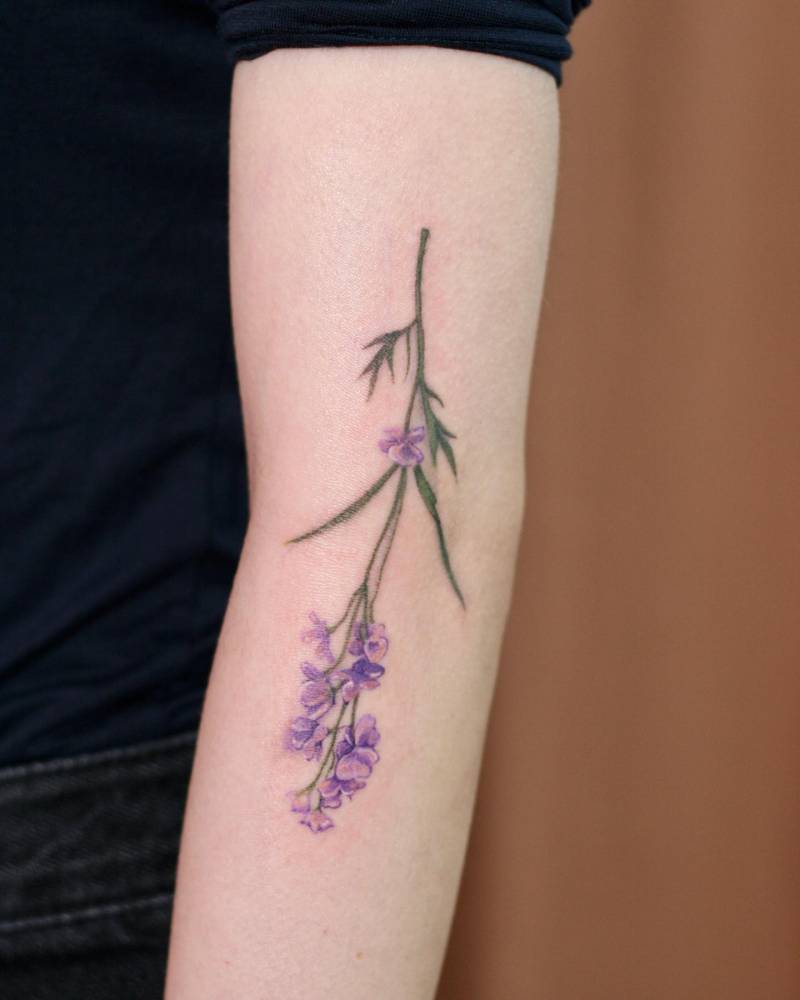 Lavender tattoo in watercolor style located on the arm.