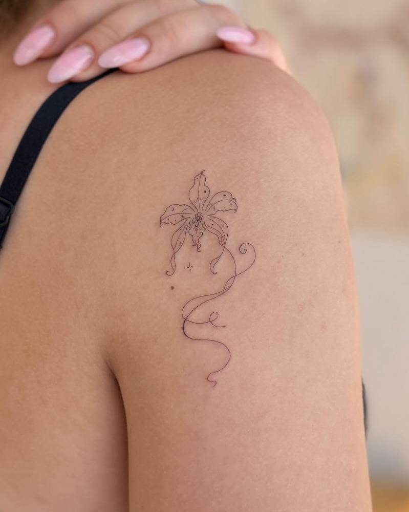 Orchid tattoo in fine line style located on the shoulder.