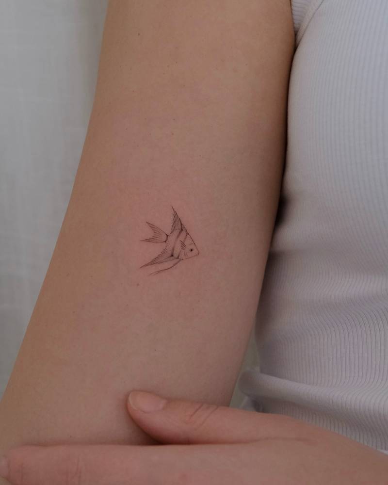 Moorish idol tattoo in fine line style located on the inner arm.